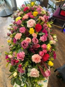 Pink and yellow Casket spray
